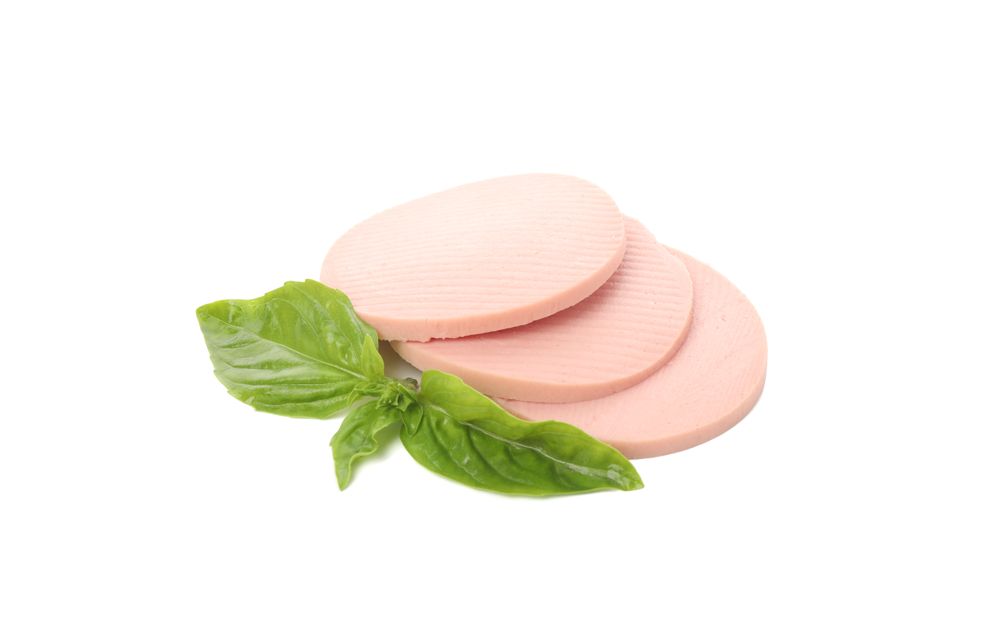 Large sausage slices in blank room with garnish