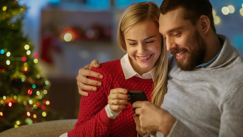 Man and Woman Sitting on the Couch Using Smartphone.