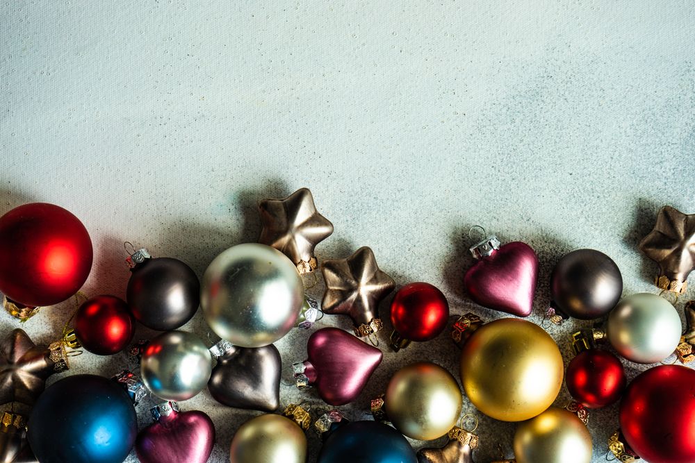 Christmas card concept of colorful baubles on concrete counter with copy space