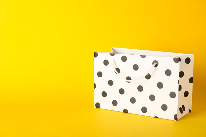 Paper bag on color background, space for text