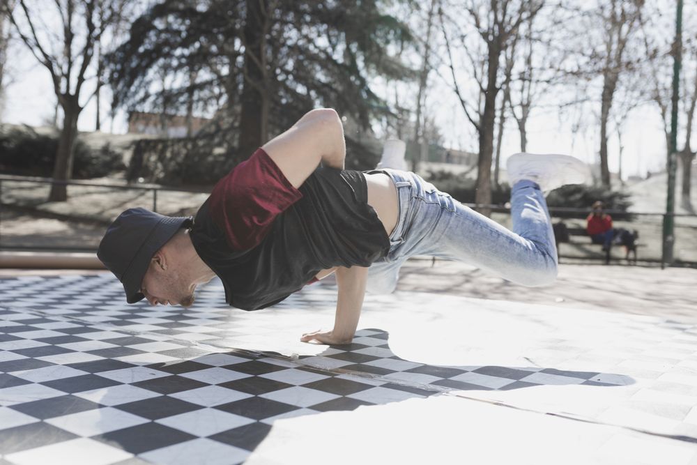 Man dancing break dance in park