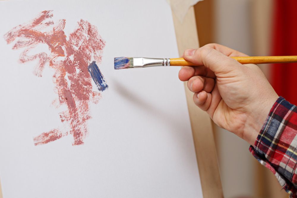 Hand of artist painting a picture
