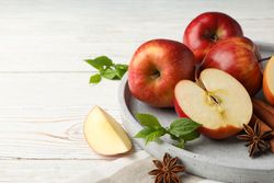 Plate of apples, anise and cinnamon sticks with copy space