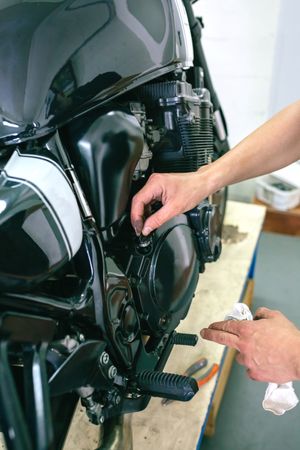 Mechanic repairing customized motorcycle