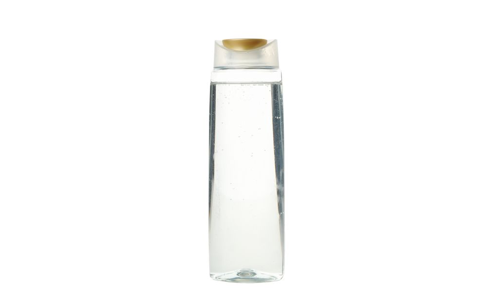 Blank plastic shampoo or lotion bottle isolated on light background