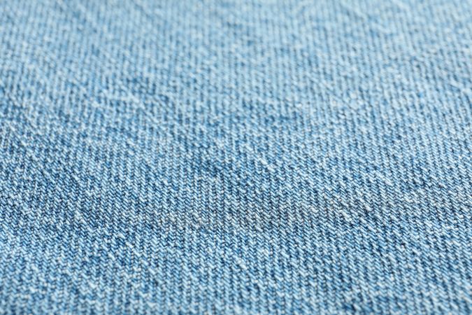 Texture of blue jeans as background, space for text