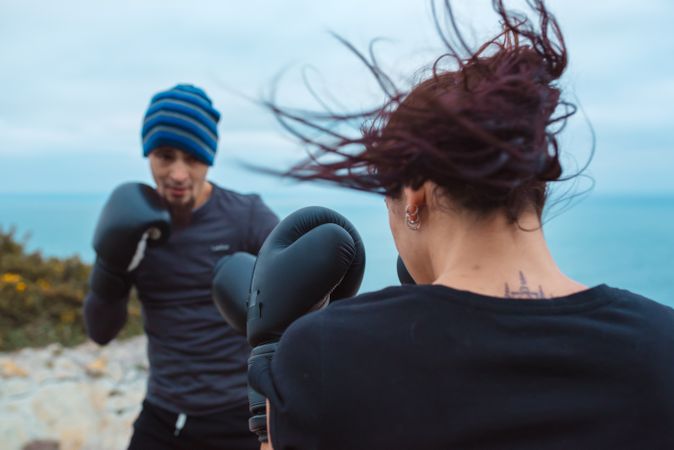 Boxers exercising on cliff