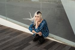 Crouched woman looking at camera