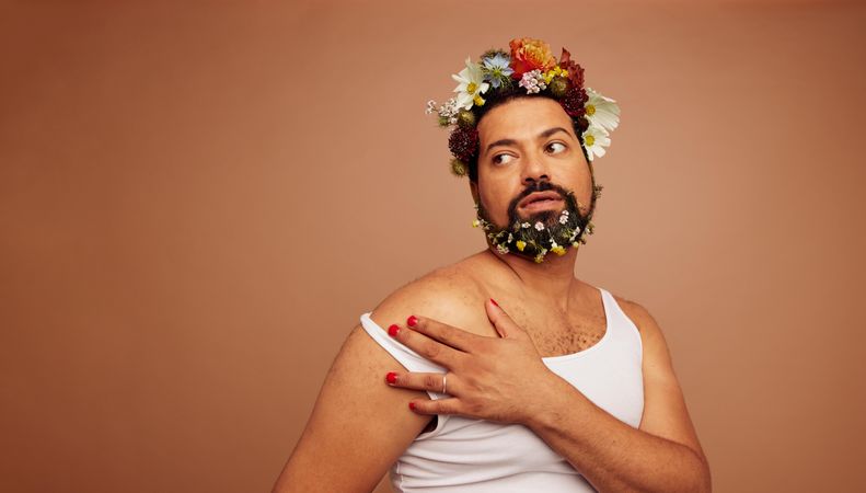 Gender fluid man wearing tank top and flowers