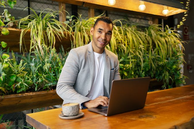 Man working on laptop at cafeteria