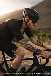 Tough and strong cyclist riding hard outdoors 42wQ3b