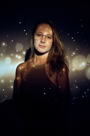 Indifferent woman under sparks projection