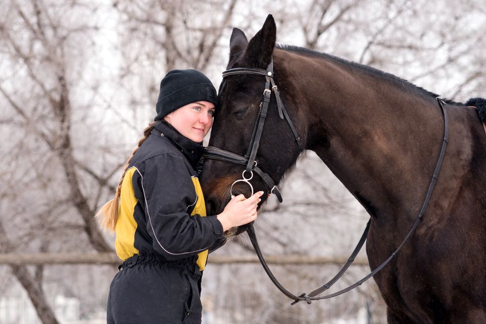 Close bond between person and horse in winter.