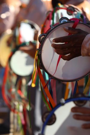 Close-up shot of people playing tambourine at the traditional religious festival of Minas Gerais in Brazil