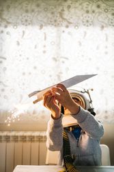 Dreamy kid having fun with toy airplane
