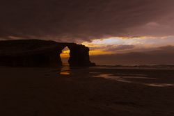 Beautiful evening sky over waving sea and shore