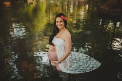 Pregnant woman standing in lake water