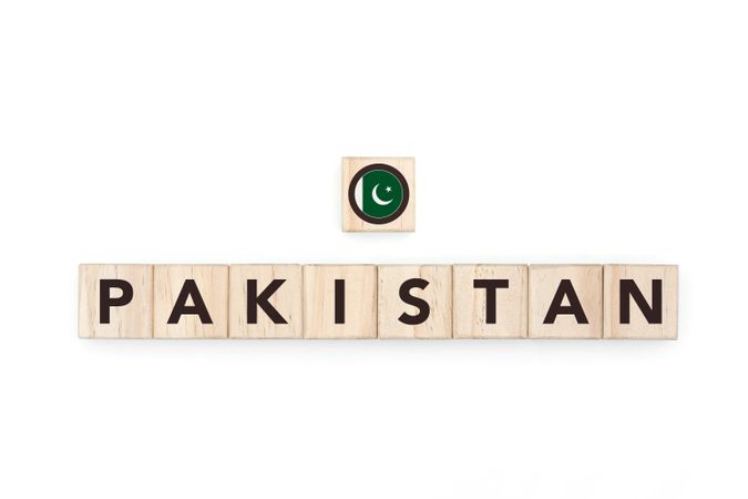 Wooden blocks bearing the name and flag of Pakistan. Pakistani, Islamic and Asian Culture, national identity, travel, and geography in a copy space design.