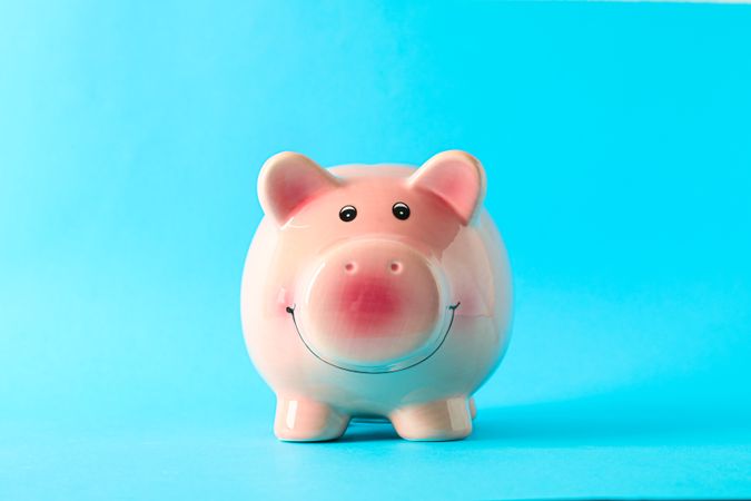 Happy piggy bank on color background, space for text. Finance, saving money