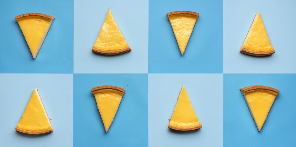 Homemade cheesecake slices on blue shaded squares