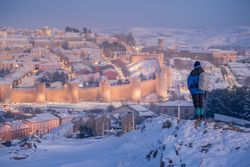 Hiker watching panorama of snowy town