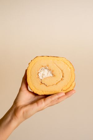 Hand holding tasty banana cake