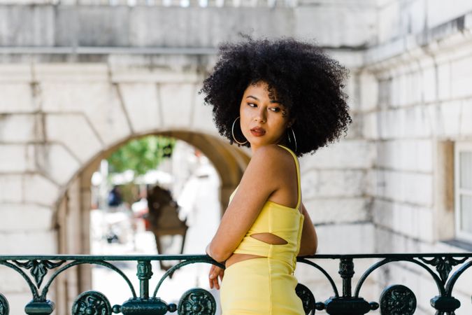 Stylish female leaning on railing outdoors