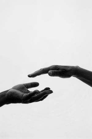 Monochrome photo of two people's hands