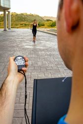 Man timing woman sprinting