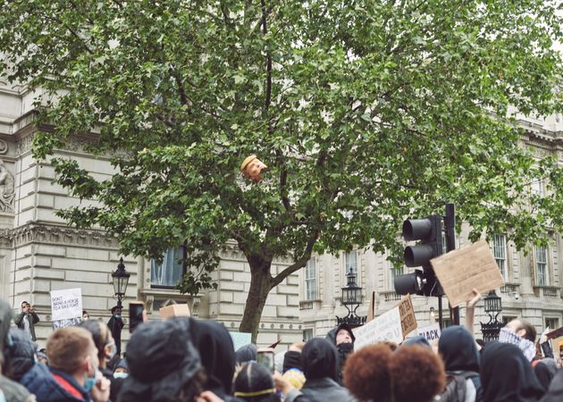 London, England, United Kingdom - June 6th, 2020: Group of protesters below a tree with Trump effigy