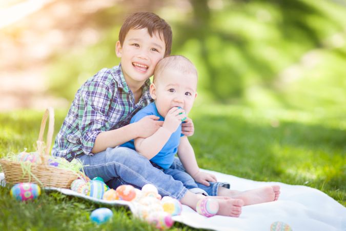 Two Boys Outside in Park Playing with Easter Eggs