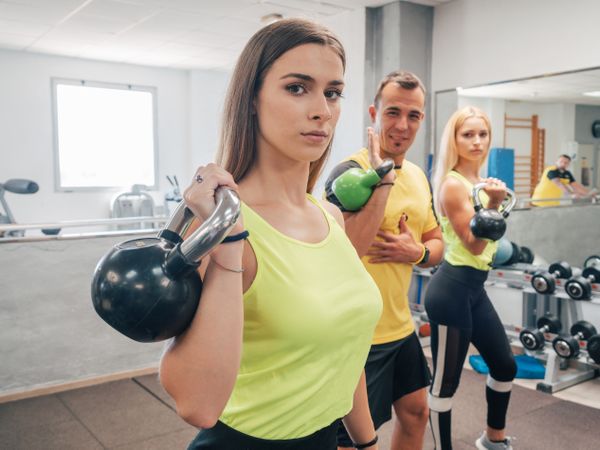 Athletes with kettlebells at the gym