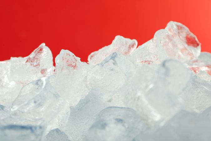 Pile of ice on red background
