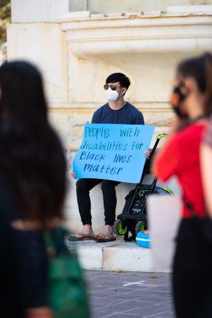 Los Angeles, CA, USA — June 16th, 2020: man sitting with homemade sign at protest rally