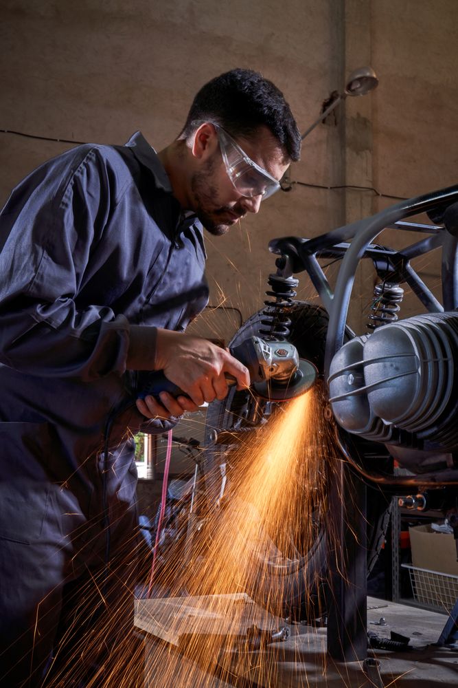 Man repairing motorbike in garage