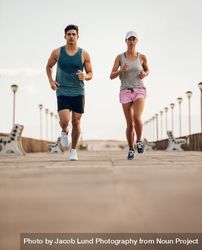 Two young people running on road 0LdakA