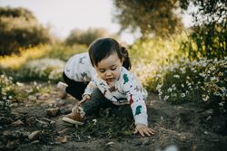 Two children playing in the dirt outside