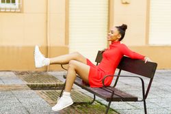 Female sitting on outside seat kicking legs