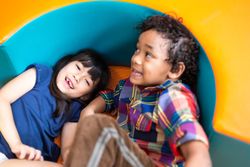 Boy and girl playing together in bright room
