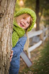 Portrait of Cute Young Girl Wearing Green Scarf and Hat