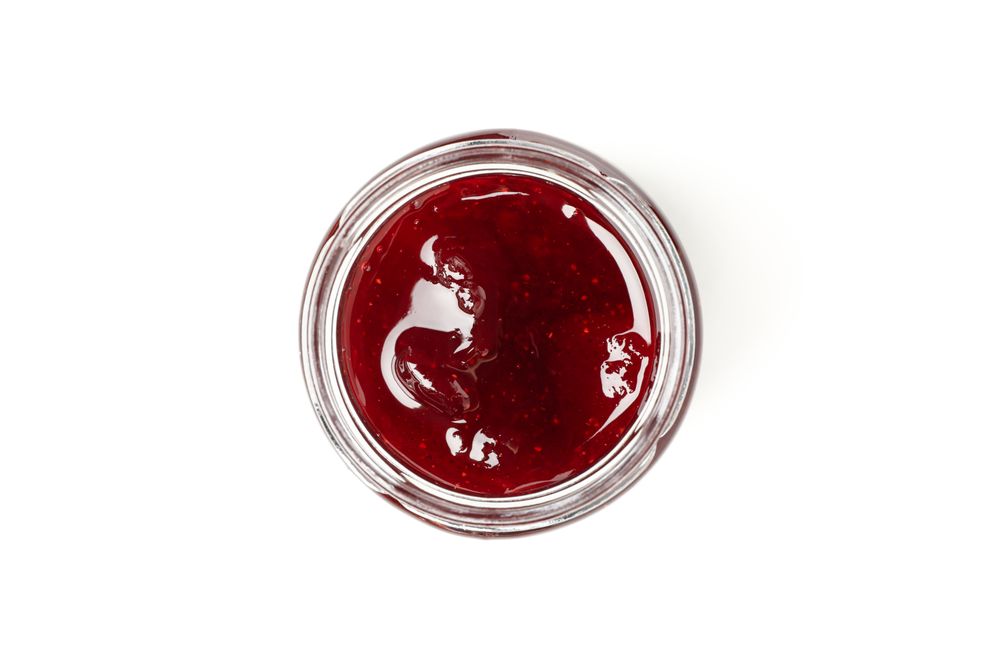 Delicious strawberry jam isolated on plain background