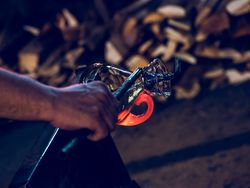 Anonymous master making glass carafe in factory