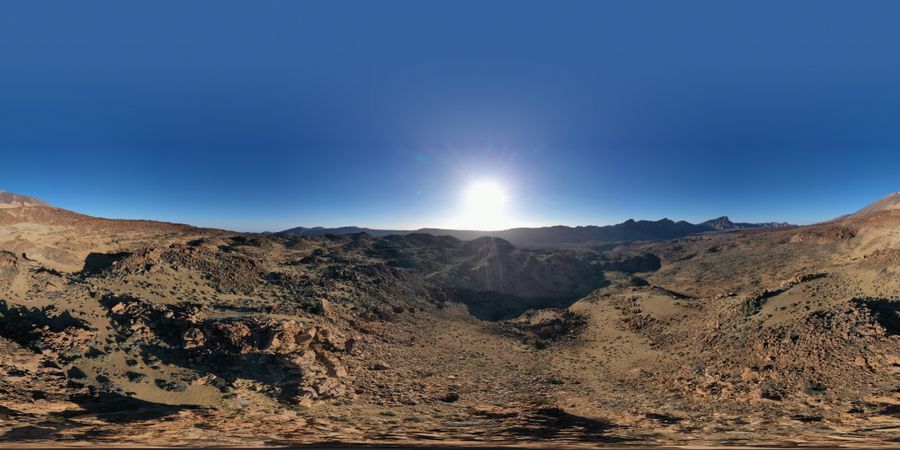 Sun shining above wild mountains