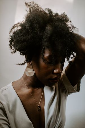 Woman in light shirt with curly hair