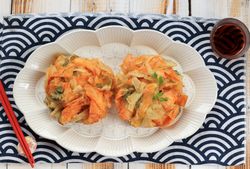 Top view of plate of kakiage vegetable tempura served with dipping sauce