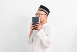 Asian Muslim man  holding quran during Ramadan