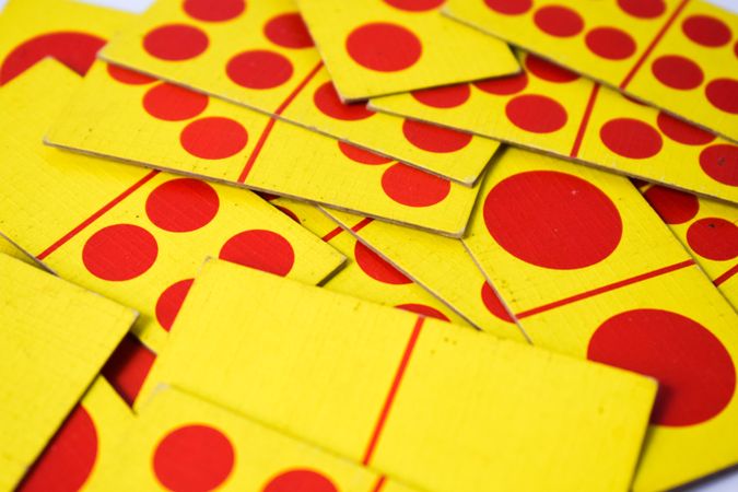 Red & yellow domino cards scattered on table