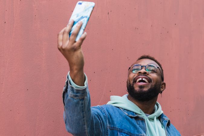 Happy man taking selfie on smartphone