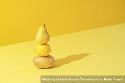 Yellow fruits and vegetables, isolated on a colored background be1plb