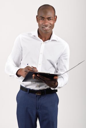 Smiling male in button up shirt holding an open folder